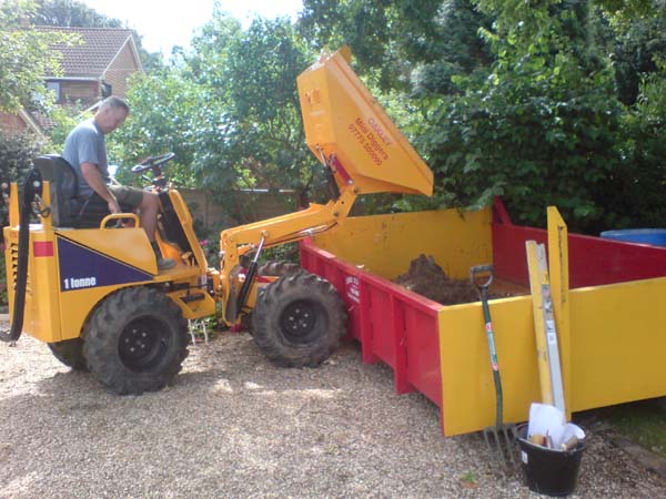 Mini Dumper tiping into a skip